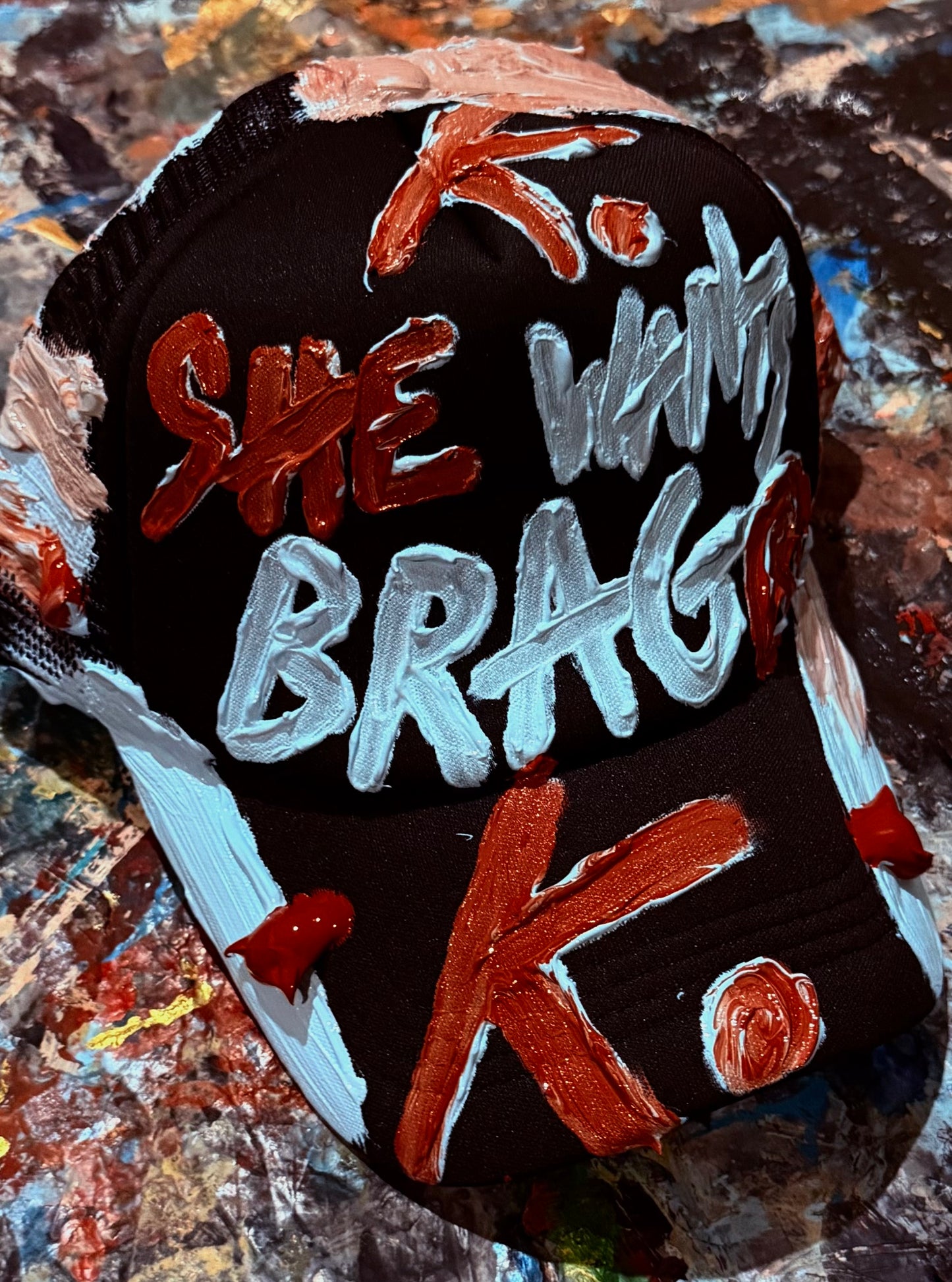 SHE WANTS BRAG K. HAT